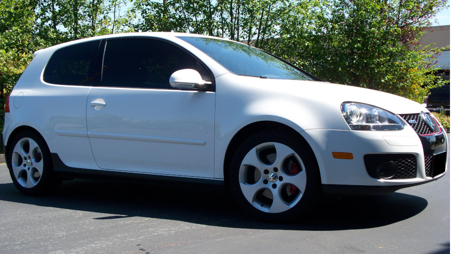 White Volkswagen Golf with tinted windows